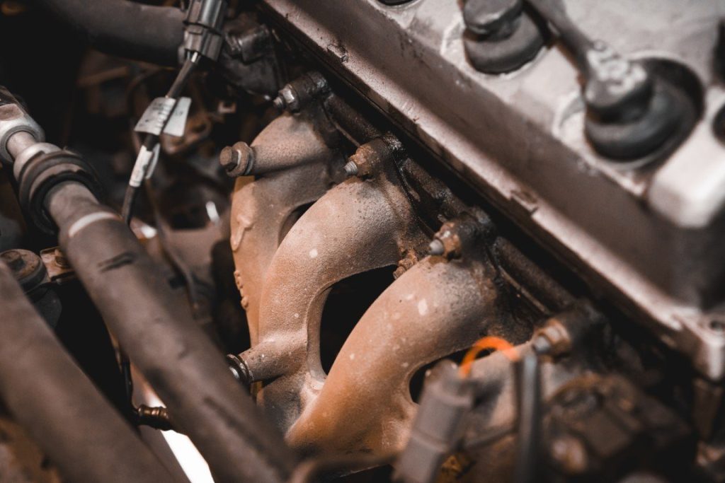 Cast iron exhaust manifold bolted to an engine block