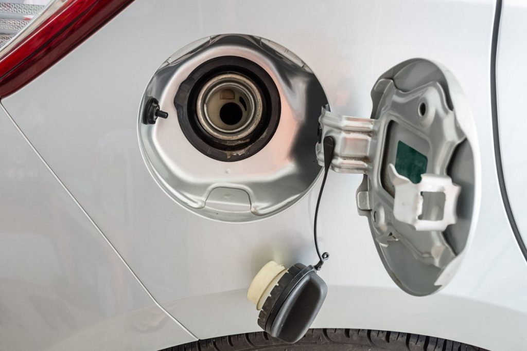 Open fuel filler door showing the gas cap on a vehicle